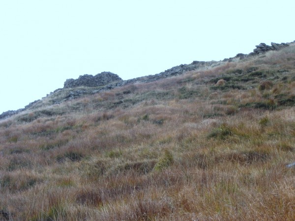 As the path rises you start to see structures a distance up the mountain on the other side of the wall.